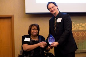 Transit Activist of the Year Awardee Lisa Franklin receiving the award from TRU chair Kelly Logan