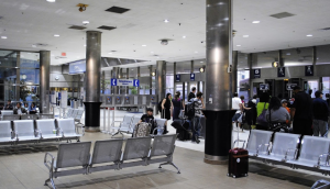 The interior of Detroit's Amtrak station, with rows of seating and people in line