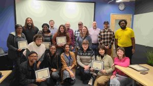The graduating class of TRU's 2024 Transportation Civic Academy, holding their diplomas!
