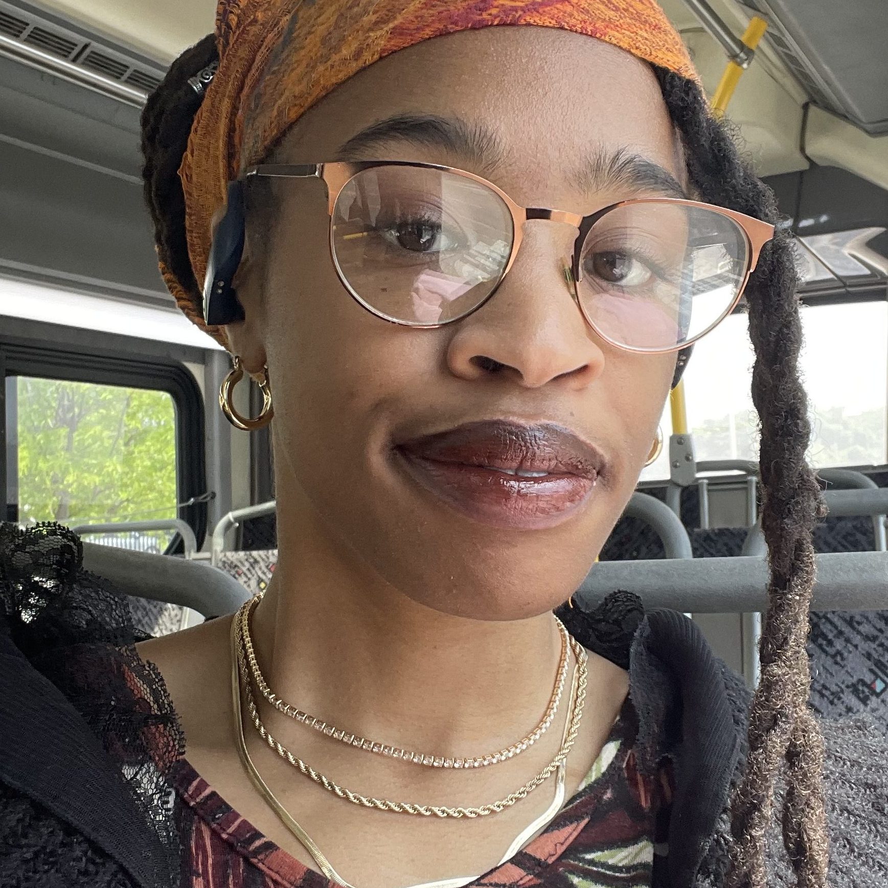 Za'Nyia on a bus, looking at the camera
