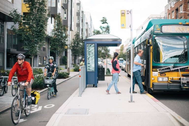 Multimodal transportation scene in a city, with bus lanes, biking, and BRT