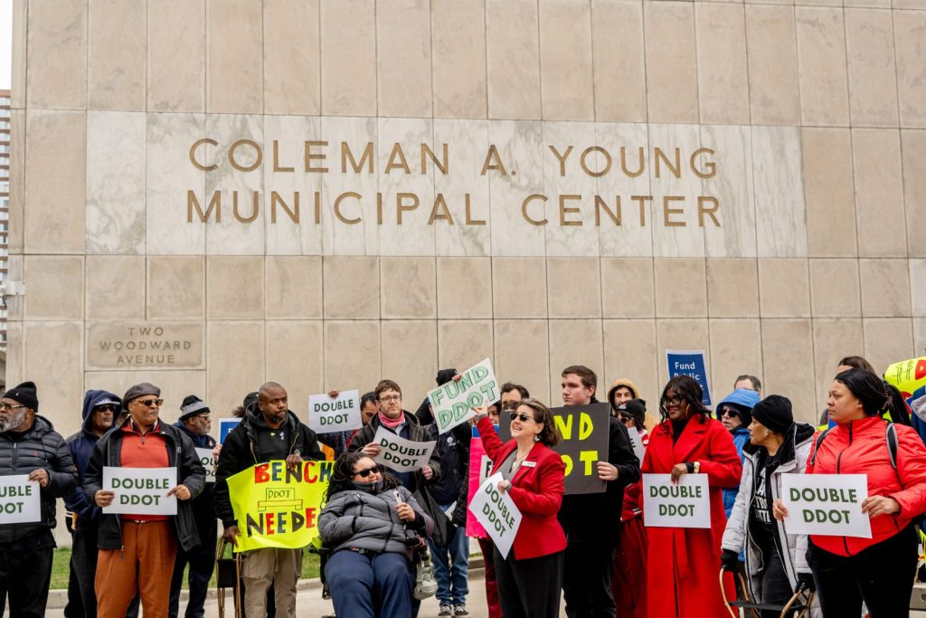TRU members and allies rallying outside Colemany A. Young Municipal Center during City budget hearings, calling for the City to Double DDOT