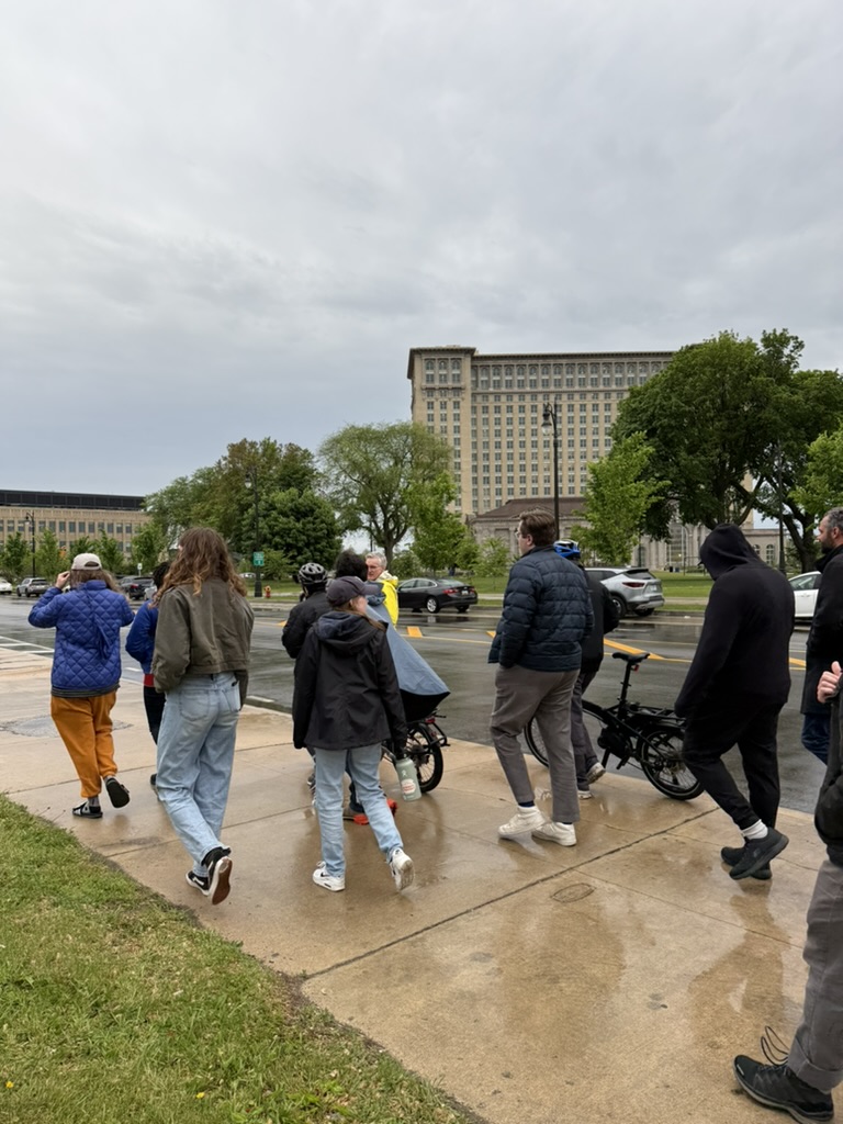 Group walking in front of Michigan Central