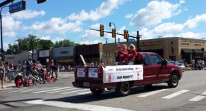 Keep SMART rolling advocates on a truckbed, in a town parade