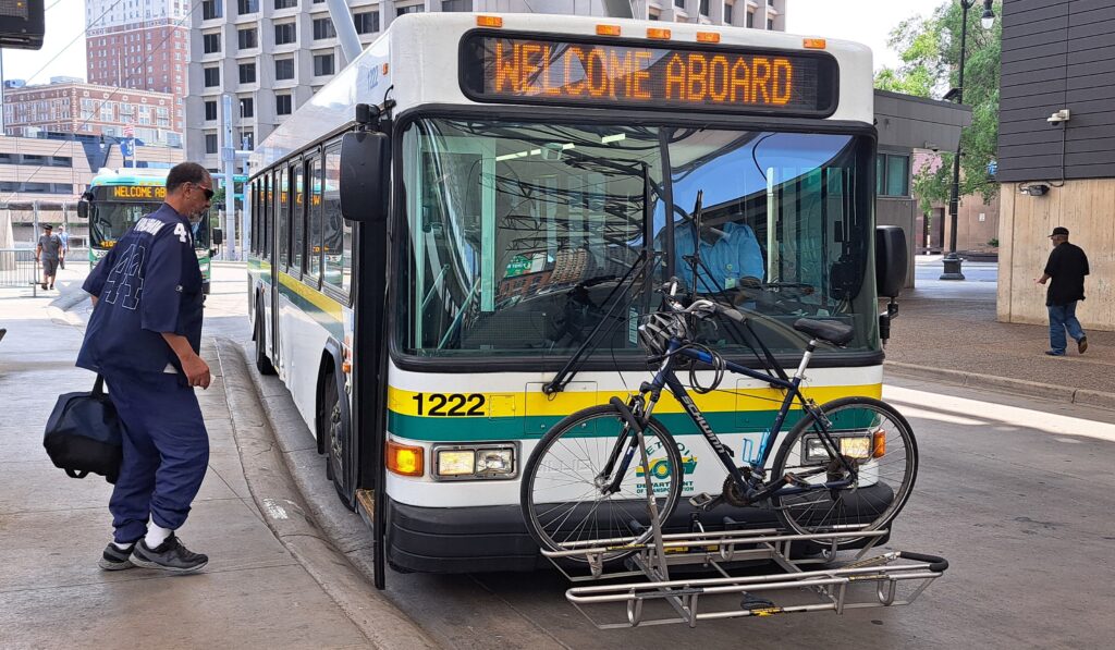 A rider boards a DDOT bus at Rosa Parks Transit Center.