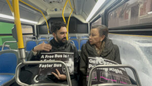Zohran Mamdani talks with a rider on a New York City bus.