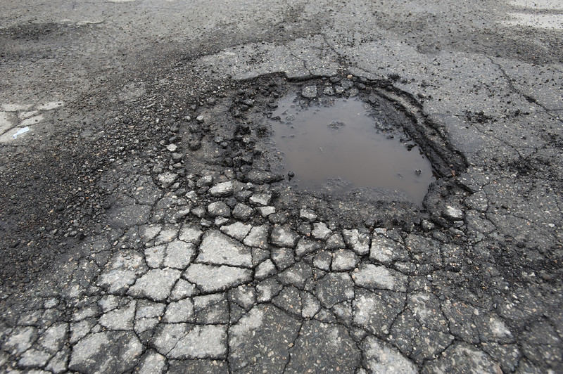 A pothole on a road.