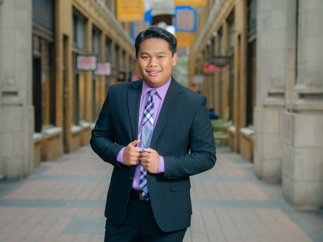Aaron Puno standing in Nickels Arcade, Ann Arbor