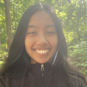 Kiersten, TRU's Research Fellow, in a forest