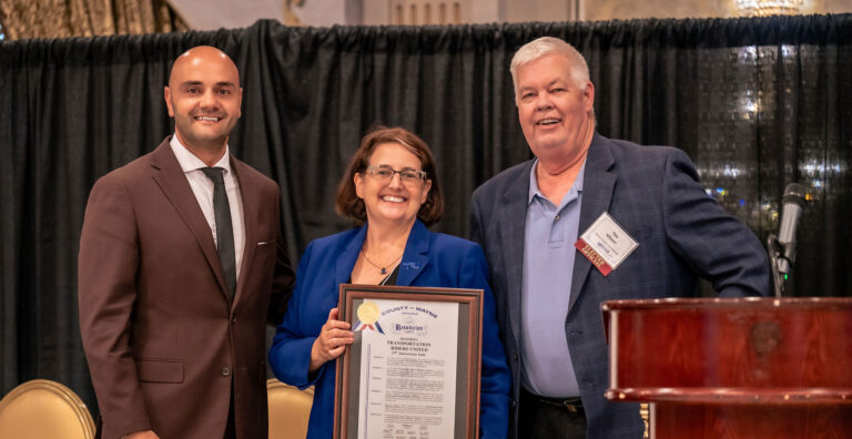 Megan receiving an award from Wayne County, acknowledging TRU's public service fighting for public transit