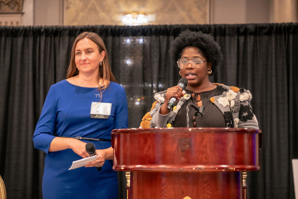 Gillian and Farai speaking on stage