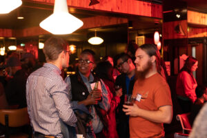 Group gathered in a bar chatting and having a good time
