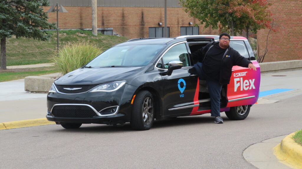 Black man exiting a SMART Flex van