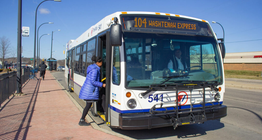 TheRide's 104 Washtenaw Express in Arborland, with a woman boarding the bus. Photo from TheRide