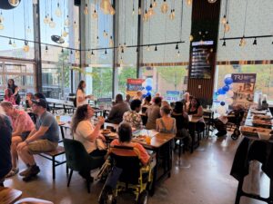 A crowd inside a restaurant celebrating the recent Wayne countywide transit vote